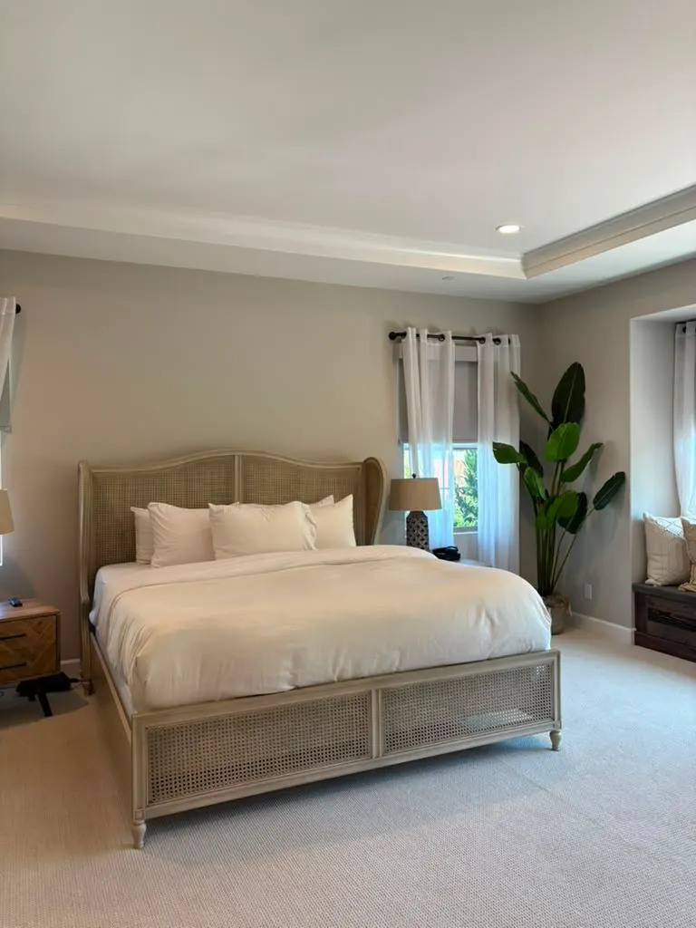 Short-term rental bedroom with fresh linens after a turnover cleaning
