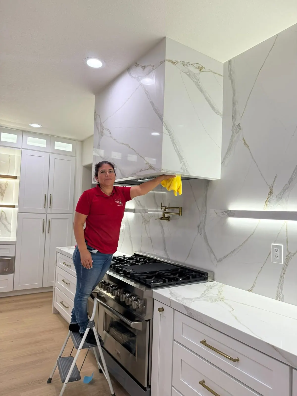 Orozco's team member cleaning a kitchen hood in an Orange County home